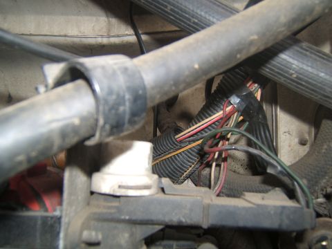 1988 Ford Bronco - A close-up view of the engine bay shows a complex wiring harness with multiple wires secured by black tubing and tape.
