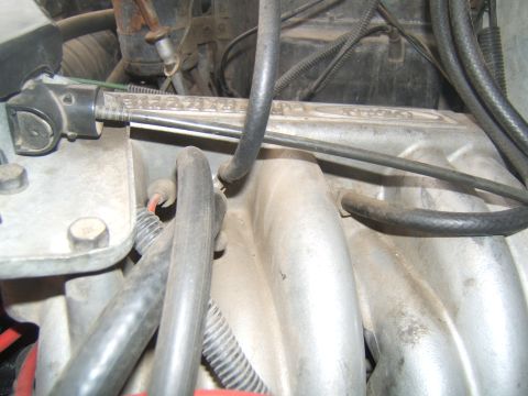 1988 Ford Bronco - Close-up view of an engine's intake manifold, showing various hoses and electrical wiring connected to it.