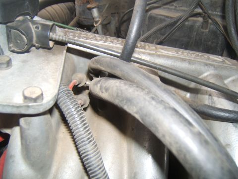 1988 Ford Bronco - Close-up view of engine components, including hoses and wiring, in a vehicle's engine bay.