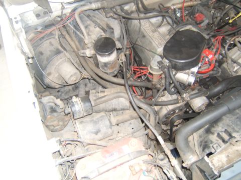 1988 Ford Bronco - A close-up view of a vehicle's engine bay, showing various components and wiring.
