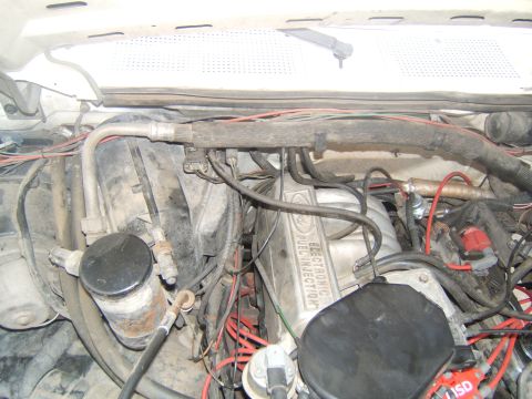 1988 Ford Bronco - Close-up of an engine bay, showing the "ELECTRONIC FUEL INJECTION" text on the valve cover.