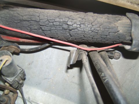 1988 Ford Bronco - Detail of aged and cracked insulation on a vehicle component, with associated wiring and hoses.