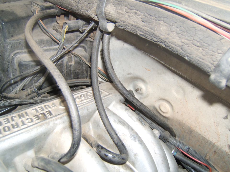 Engine bay with hoses and wiring. Text reads "ELECTRONIC FUEL INJECTION"