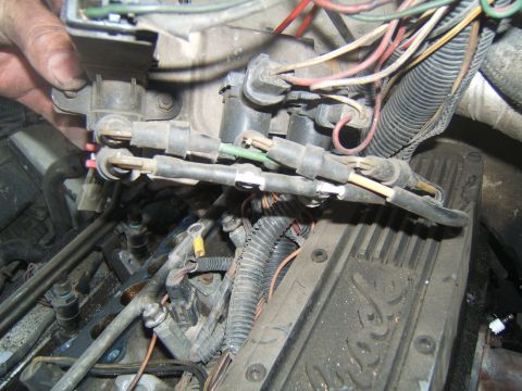 1988 Ford Bronco - Close-up view of engine components, including wiring and a valve cover.