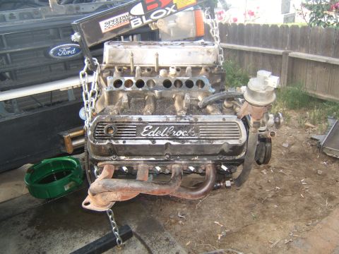 1988 Ford Bronco - A Ford V8 engine, identified by the Ford emblem on the grille in the background, is the focus of this image.