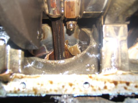 1988 Ford Bronco - This image shows internal engine damage, specifically to the crankshaft and connecting rod assembly.