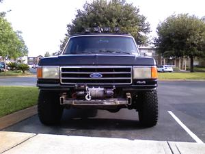 1990 Ford Bronco - Front view of a 1990 Ford Bronco equipped with a brushguard and winch.