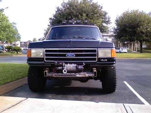 1990 Ford Bronco - Front view of a 1990 Ford Bronco equipped with a winch and roof-mounted light bar.