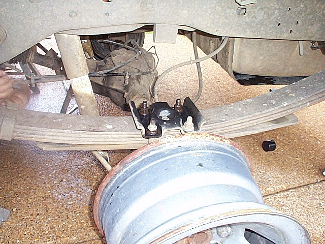 The nuts on the U-bolts are soaking in Liquid Wrench (or some other penetrating oil).  I washed all the dirt off a few days ago & then kept them wet with oil until now.

The bare rims will make it easier to move after it's on the ground.