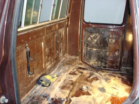 1979 Ford F-250 - The interior of a truck bed shows signs of wear and tear, with the door panel removed.