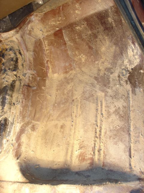 1979 Ford F-250 - Close-up view of a vehicle's interior floor pan, showing wear and tear.