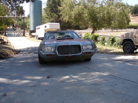1973 Ford Ranchero - A weathered 1972 Ford Ranchero is parked in front of a rural setting with a horse trailer and another truck nearby.
