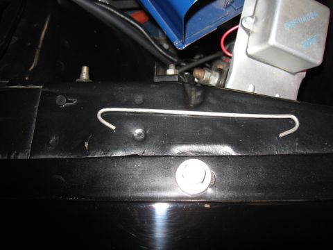 1968 Shelby GT500 - A metal bracket is secured with a bolt in the engine compartment, with wiring and a silver box visible.