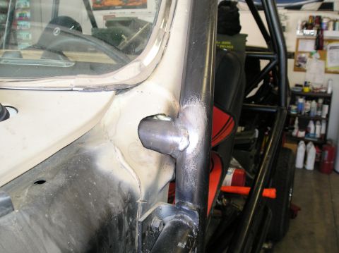 1986 Toyota Hilux - Roll cage fabrication in progress, showing welding on the vehicle's A-pillar.
