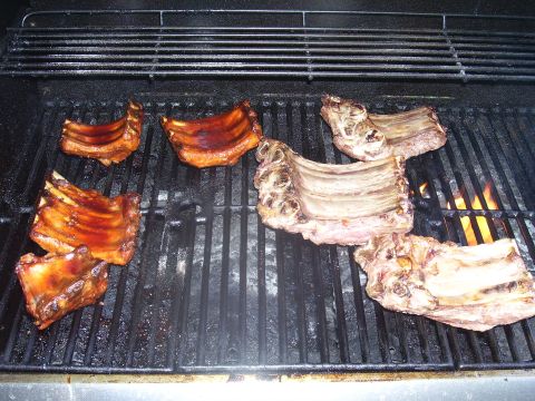 1991 Ford Bronco - Several racks of ribs are being grilled over an open flame.