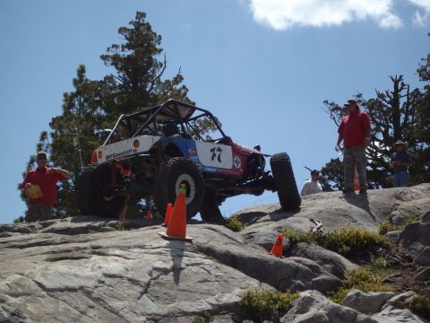 1982 Toyota Pickup/SR5 - An off-road buggy navigates a rocky terrain during a competition.