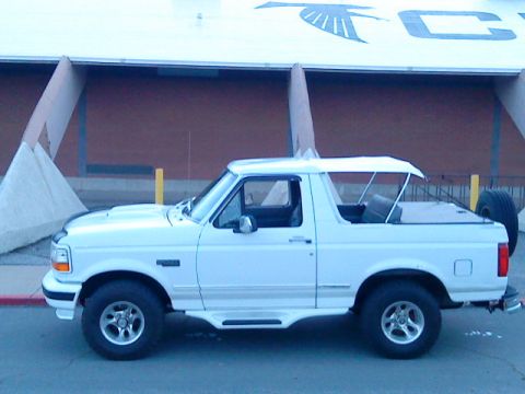 1995 Ford Bronco - This white 1995 Ford Bronco features a removable top, offering an open-air driving experience.
