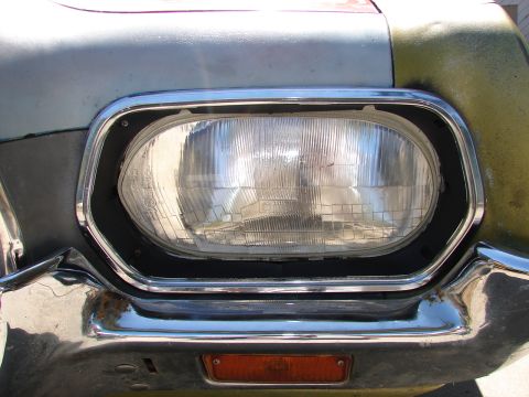 1973 Ford Ranchero - Front view of a 1973 Ford Ranchero, showing the headlight assembly and chrome bumper.