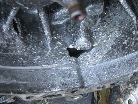 1994 Ford Probe - Close-up view of a heavily damaged engine block, showing a significant breach in its casing.