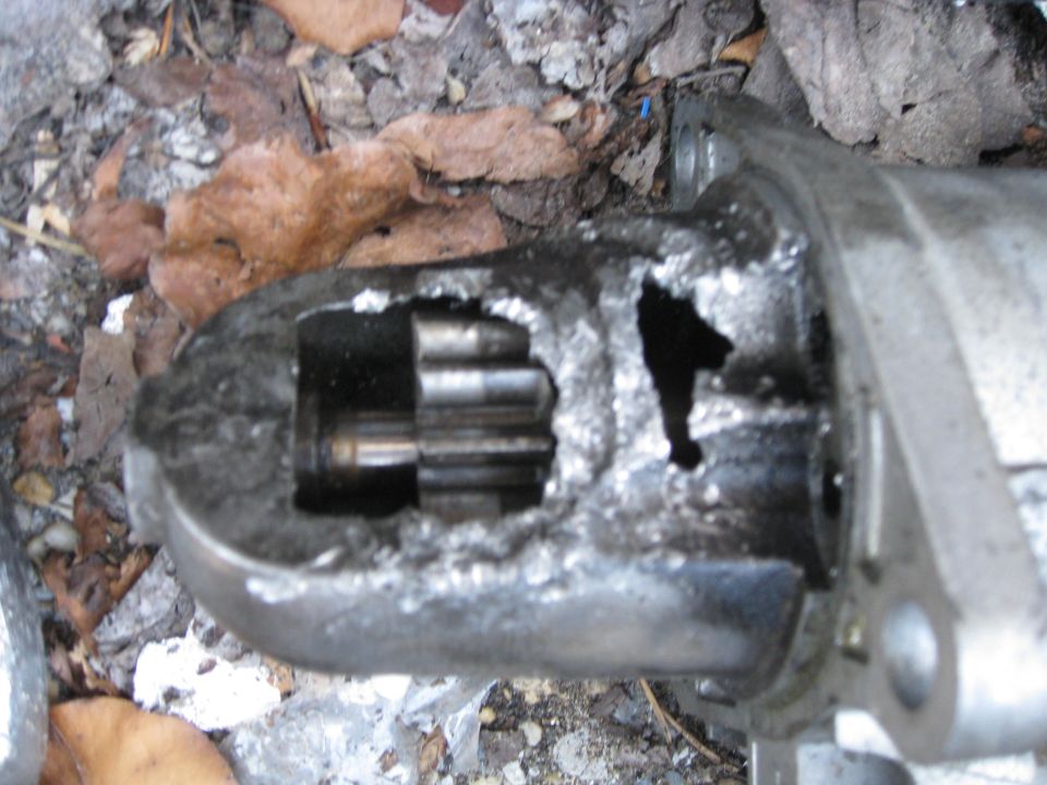 close-up of a broken starter motor with visible gears