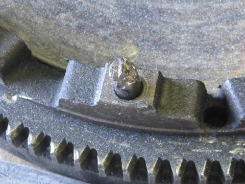 1994 Ford Probe - A close-up view shows a damaged bolt on a toothed metal component, possibly a flywheel.