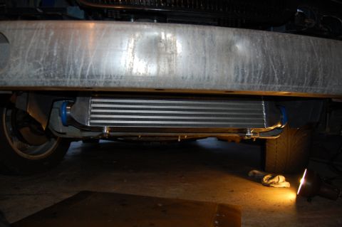 1985 Mercury Grand Marquis - An aftermarket intercooler is installed beneath the front bumper of a vehicle.