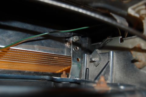 1985 Mercury Grand Marquis - Detail of a car's interior component, showing wiring and a metal bracket.