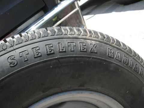 1986 Ford Bronco - Close-up of a STEELTEX RADIAL tire, showing tread pattern and sidewall lettering.