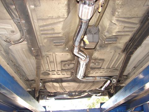 1992 Ford Taurus - The underside of a vehicle is shown, highlighting a new exhaust system and fuel tank.