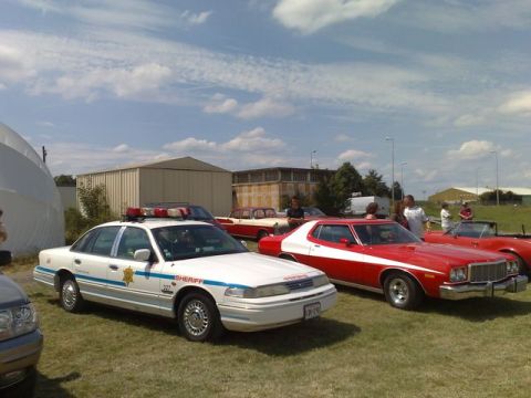 1991 Ford Crown Victoria - Sheriff car and other classic vehicles on display at an outdoor event.