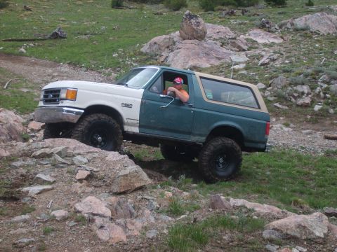 1989 Ford Bronco - This modified Ford Bronco is shown off-roading on a rocky trail.