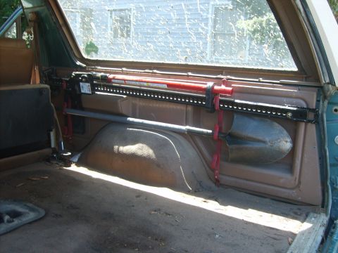 1989 Ford Bronco - A shovel and a Hi-Lift jack are mounted inside the vehicle's cargo area.