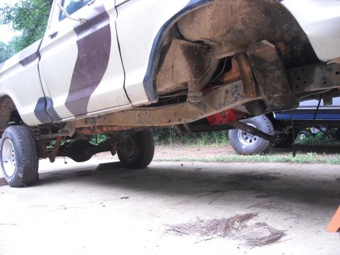 1979 Ford F-150 - Undercarriage view of a pickup truck with visible rust and camouflage paint.