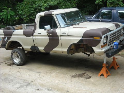 1979 Ford F-150 - This 1979 Ford F-150 pickup is on jack stands, missing its front wheels and undergoing maintenance.