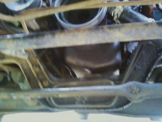1994 Ford F-250 - This photo shows the underside of a vehicle, focusing on the engine oil pan and frame components.