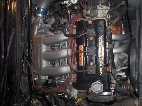 1993 Ford Probe - Engine bay detail showing a Mazda V6 DOHC 24-valve engine with a custom intake manifold and wiring.