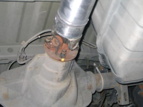 2007 Ford Mustang - Undercarriage view of a vehicle's driveshaft and differential assembly.