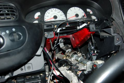 2007 Ford Mustang - Interior view of a disassembled dashboard, showing exposed wiring and steering column components.