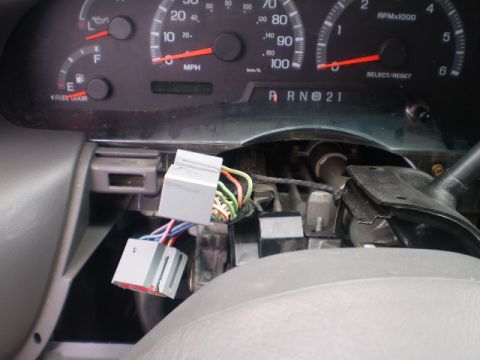 2007 Ford Mustang - Exposed wiring harness and connectors in a vehicle's dashboard area.