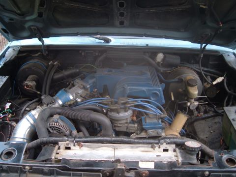 1990 Ford Ranger - Engine bay view showing the intake manifold, distributor, and wiring. Supermotors.net logo is present.