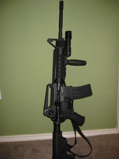 1996 Ford Bronco - Tactical rifle with attached flashlight and magazine.