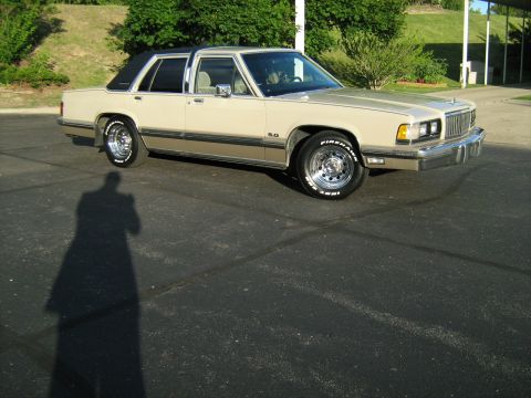 1988 Mercury Grand Marquis - A 1988 Mercury Grand Marquis is shown from the front three-quarter view, parked on asphalt.