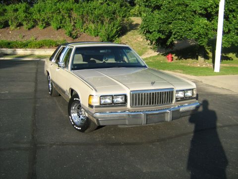 1988 Mercury Grand Marquis - This 1988 Mercury Grand Marquis is captured in a front 3/4 view, its tan exterior.