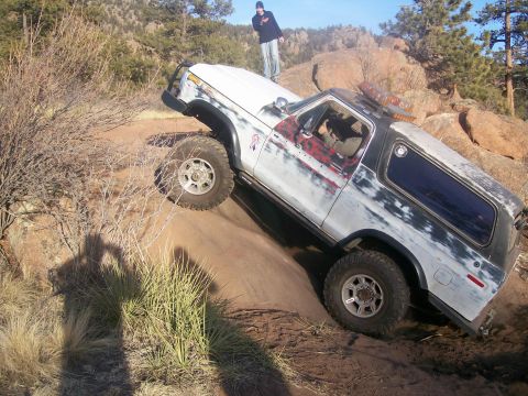 1978 Ford Bronco - This SUV is navigating a challenging off-road trail with steep inclines and rocky terrain.