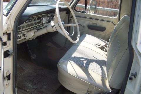 1987 Ford Bronco II - Interior of a vintage pickup truck with a two-tone seat and simple dashboard instrumentation.