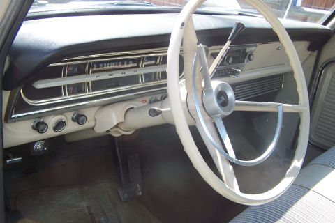 1987 Ford Bronco II - Interior view of a vintage Ford, showing the dashboard, steering wheel, and floor pedals.