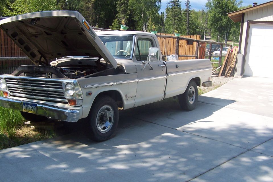 Two-tone pickup truck, hood open, showing engine. Front 3/4 view