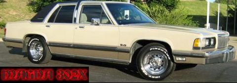 1988 Mercury Grand Marquis - 1988 Mercury Grand Marquis sedan in a three-quarter front view, a beige body and a black vinyl roof. The "5.0" badge is visible on the fend…
