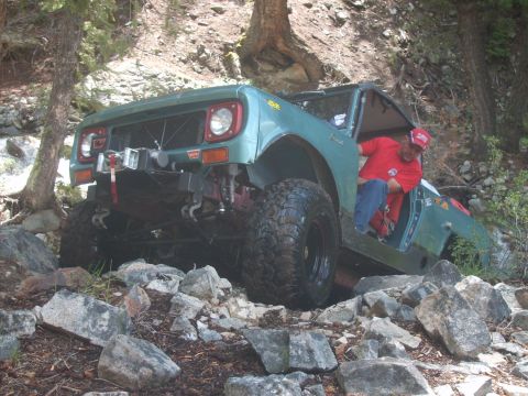 1989 Ford Bronco - This International Scout II is navigating a challenging rocky incline.
