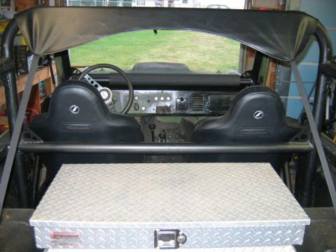 1992 Ford Mustang - The interior of a vintage vehicle, possibly a 1970s Bronco, is shown with racing seats and a roll cage.